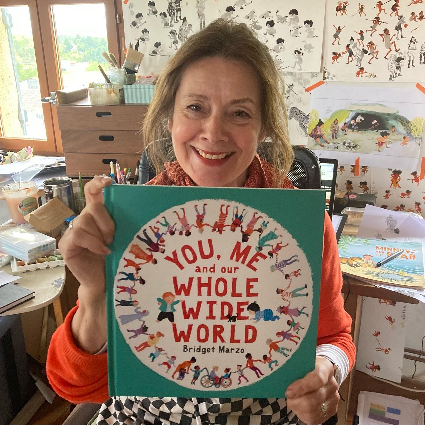 Bridget Marzo with her picture book You, Me and Our Whole Wide World